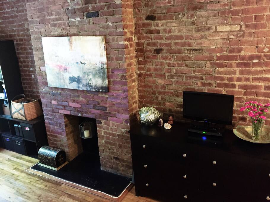 Exposed brick wall. Dresser for storage