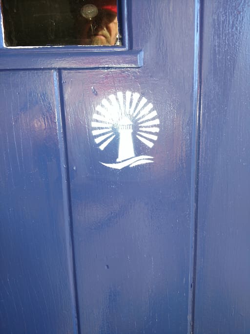 You know you're at the right house because of the distinctive blue front door and white logo.