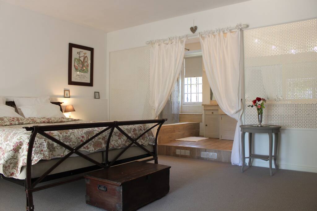 Refurbished ground floor superking bedroom with en-suite bathroom and wisteria clad terrace.