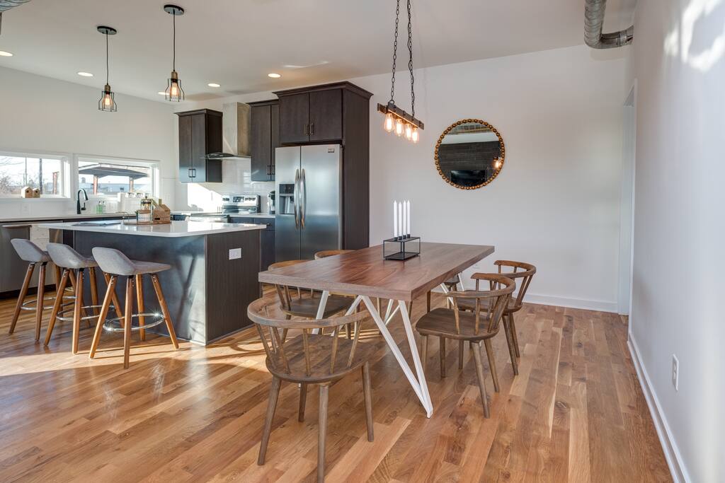 An industrial chandelier adds character to the dining area.