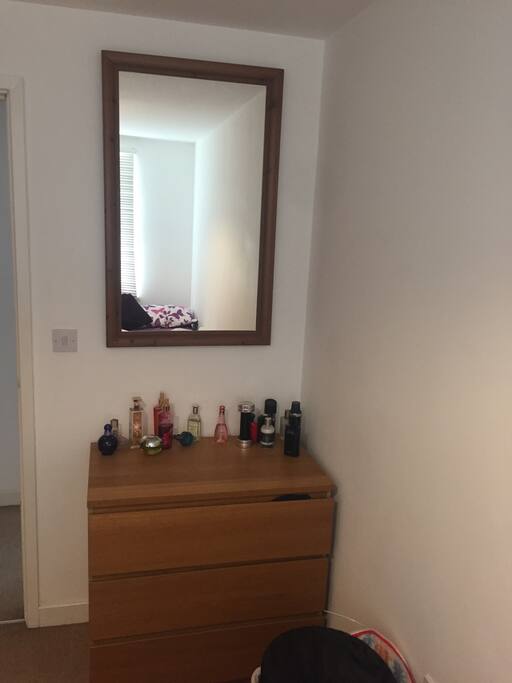 Large mirror and dresser in the bedroom