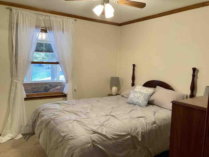 Guest bedroom with queen bed, dresser, full size closet