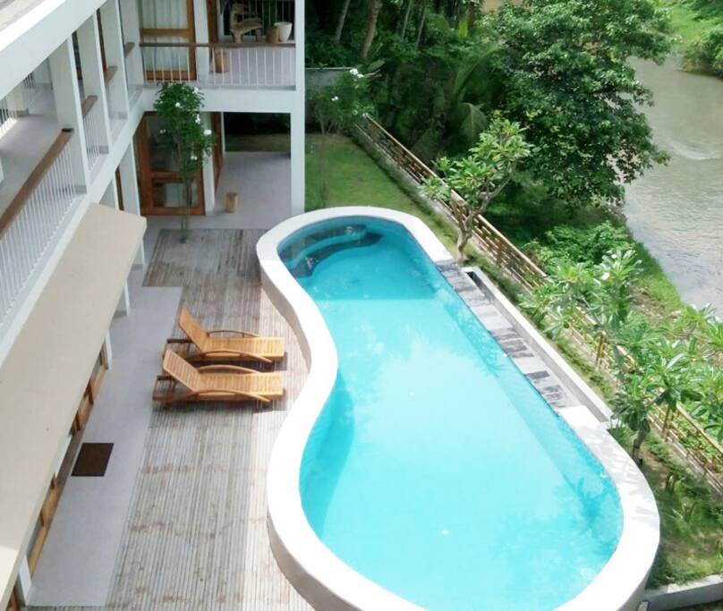 Organic shape pool next to ubud river