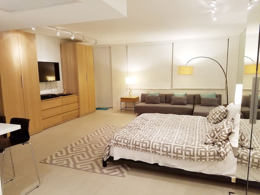 Beautiful modern living space - windows allow plenty of light in the day time, door leads out to spacious balcony with chaise lounge for sunbathing. Couch can be combined to make a queen bed