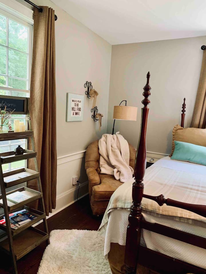 Spavaća soba s velikim bračnim krevetom u prizemlju – vidi se kožna fotelja i veliki bračni krevet