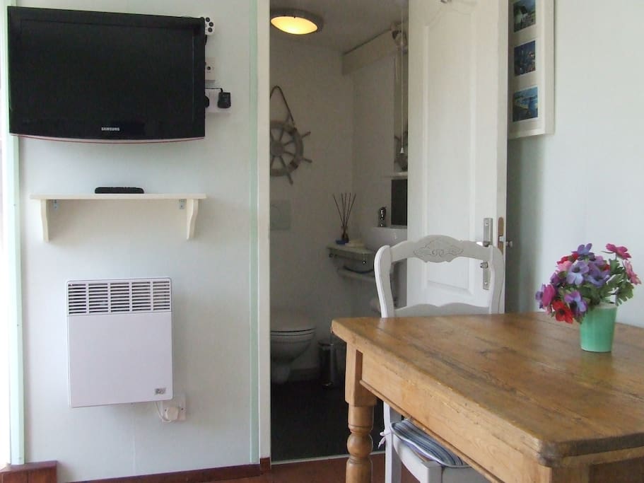 The TV, ensuite and dining area