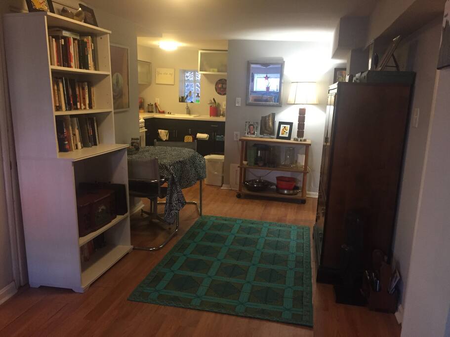 Bookcase with record player, dining table, kitchen and dresser.