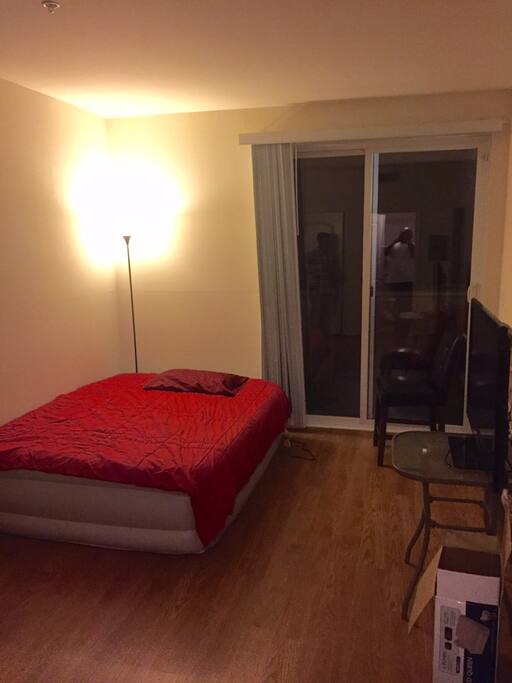 bedroom with patio door and TV
