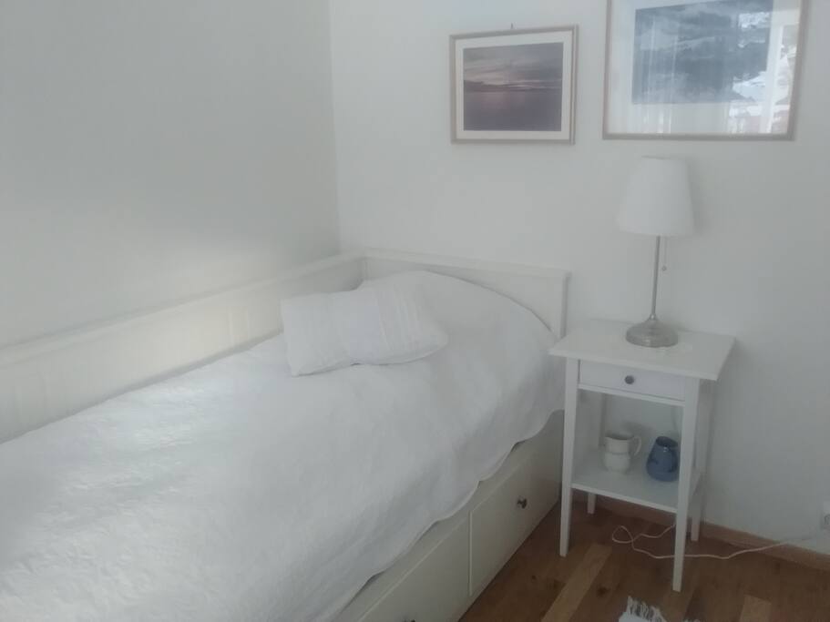 This bed can also be a double bed. Private terrace ouside the room with view to a big riverr and the cebter of Ålgård.