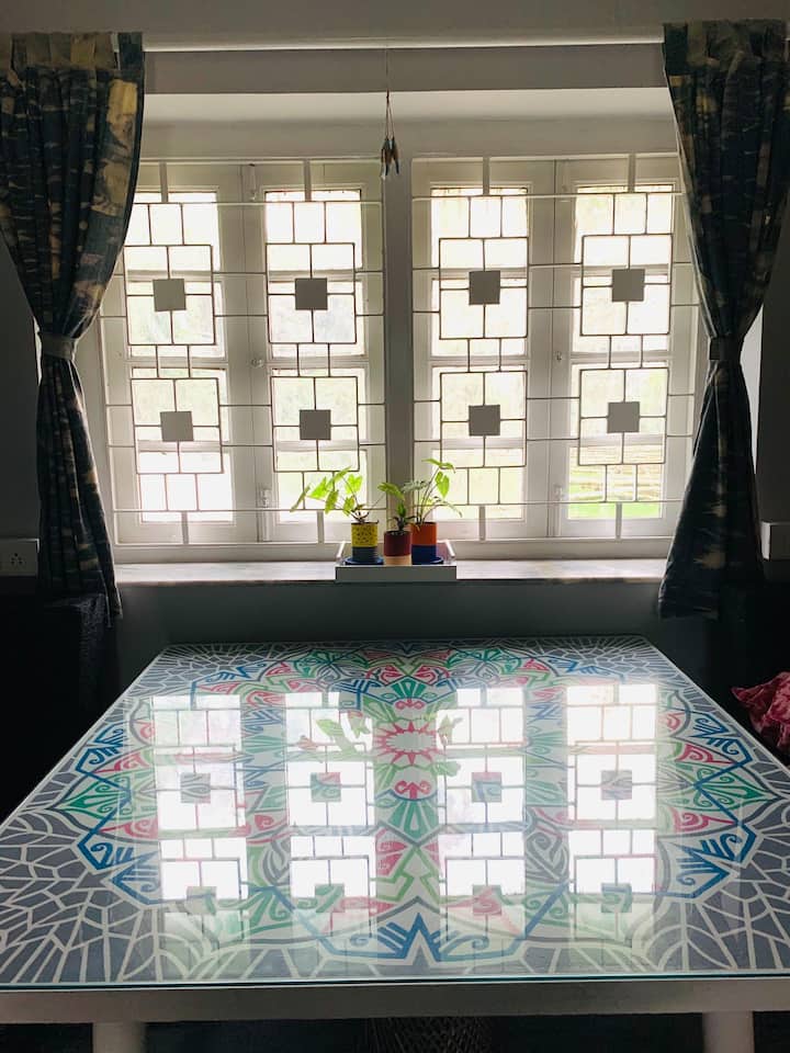 This table overlooking the backyard has been up cycled from an old table which has been hand painted by Rini. 