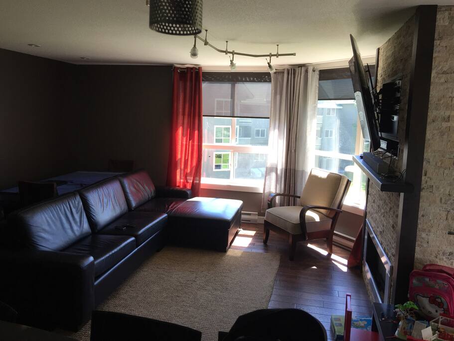 Spacious living room with dining table for 4 behind couch