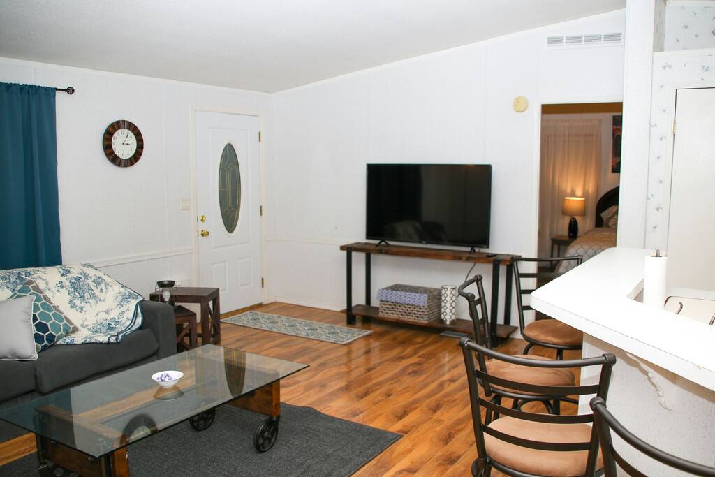 Barstools to open kitchen layout with 55" smart TV for Internet movies and more.