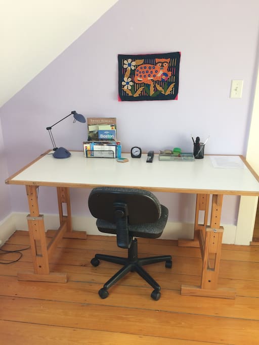 Large work surface with desk accessories and local information.