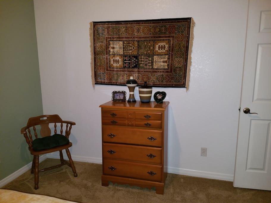 the chair, chest and picture in the room