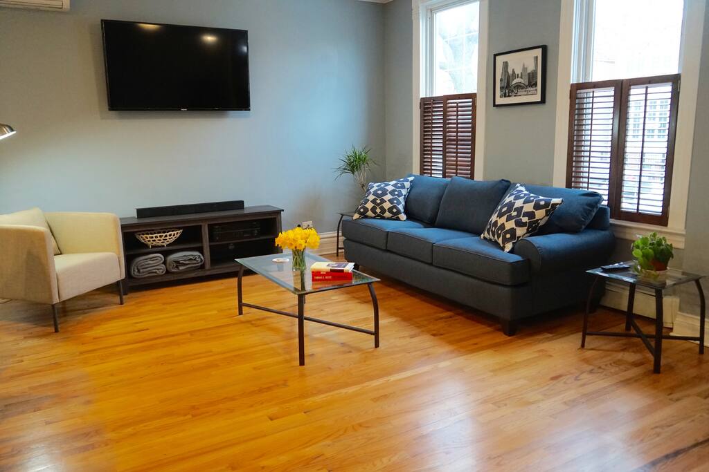 The spacious living room equipped with a memory foam, queen-size sofa bed