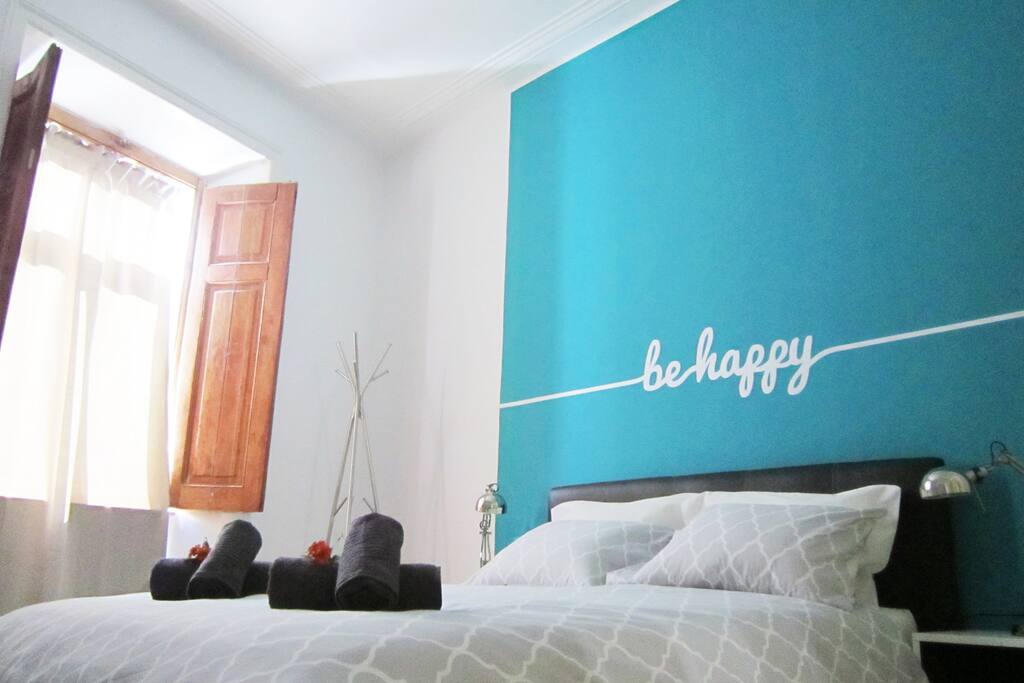 Large room with double bed, a lot of natural light