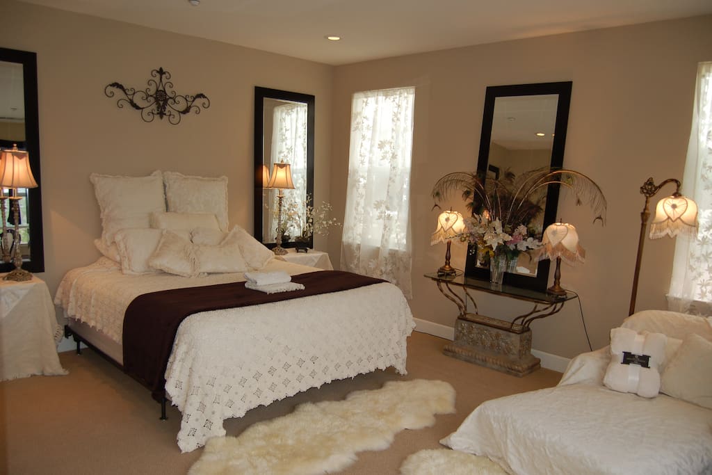 Georgous large comfortable bedroom, private TV and spacious lounging chair.