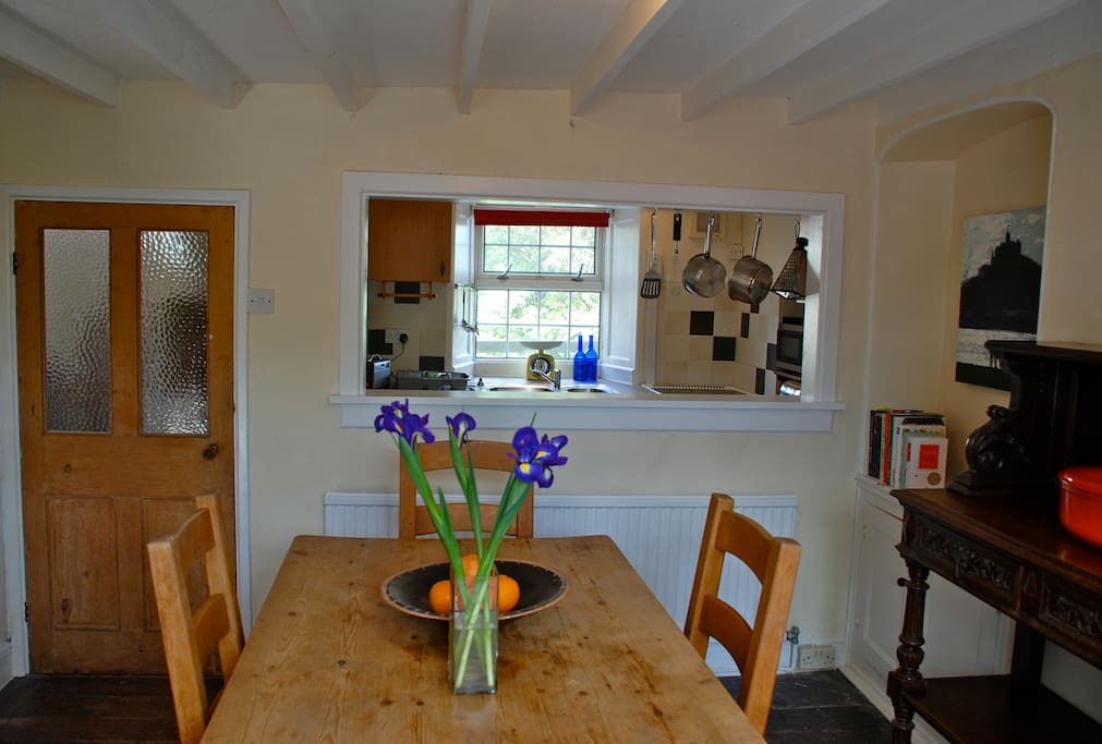 Dining table with hatch to galley kitchen.