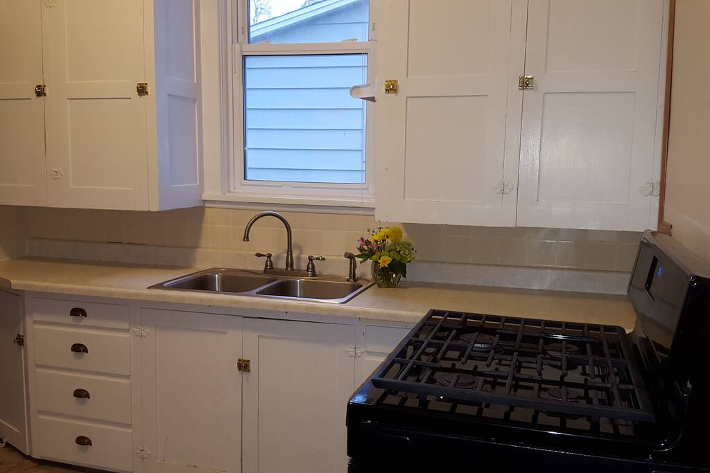 Refrigerator, gas range/oven, kuerig and coffee, dishes, pots and pans, flatware.