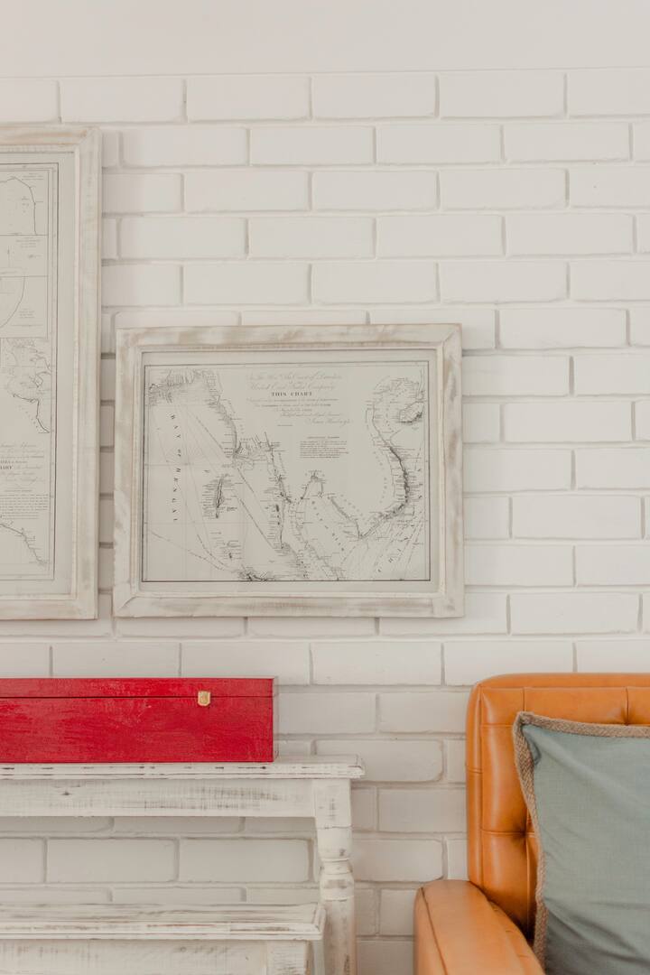 Old Maps scavenged from a boatyard and framed in distressed wood .