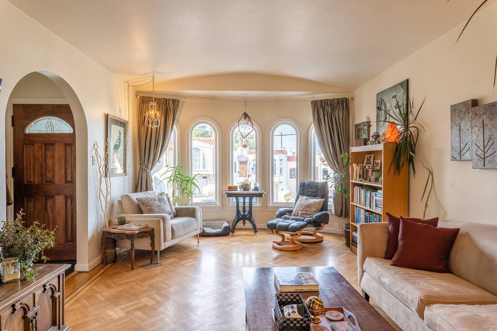 Welcome to our home. This is the front entrance and reading nook area of our living room. Sunsets are particularly lovely through the bay windows.