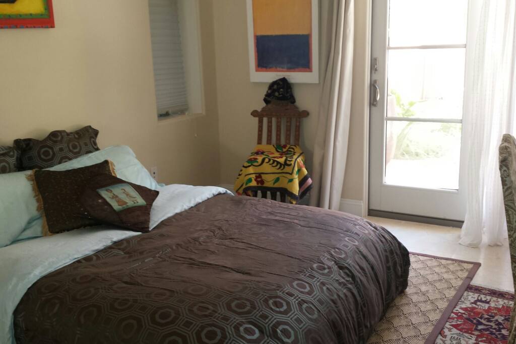 A 1st level cool bedroom with ensuit bathroom with backyard outlook.