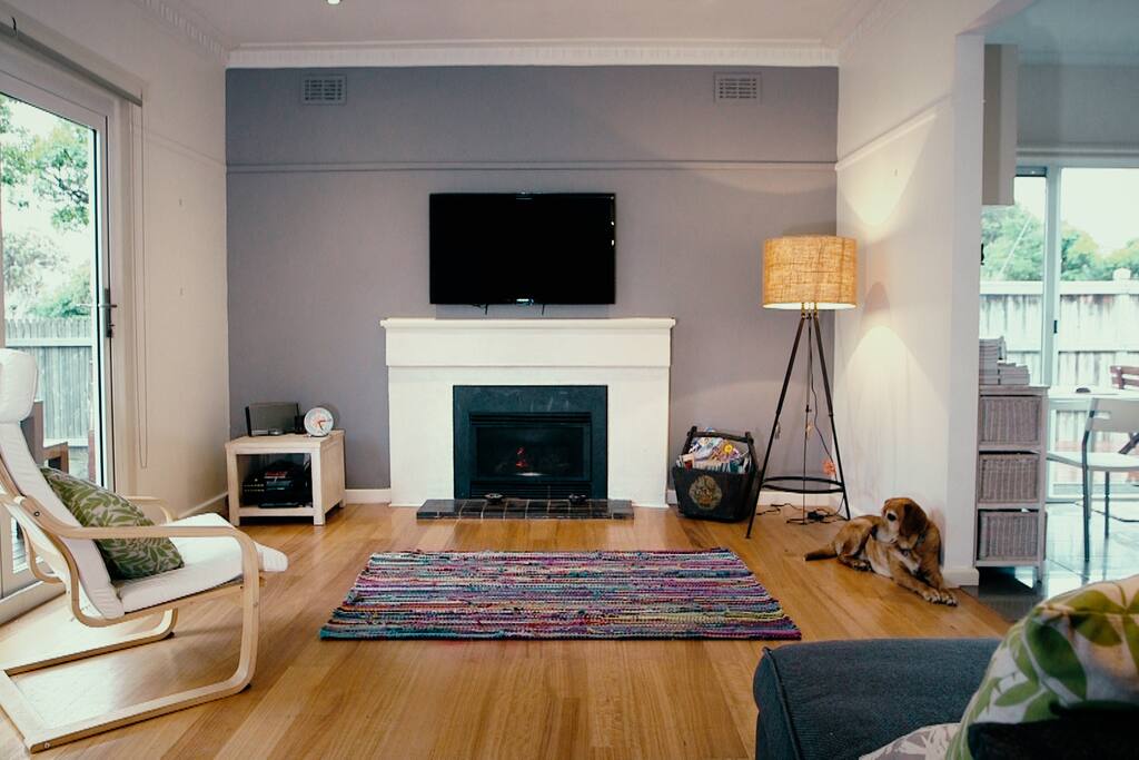 Lounge with TV and bifold doors opening onto deck & garden