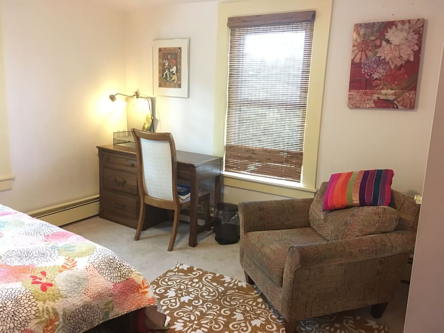 Your bedroom has a desk and easy chair.