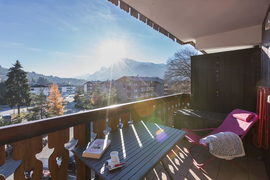 South-facing balcony sunlounger and coffee with a book