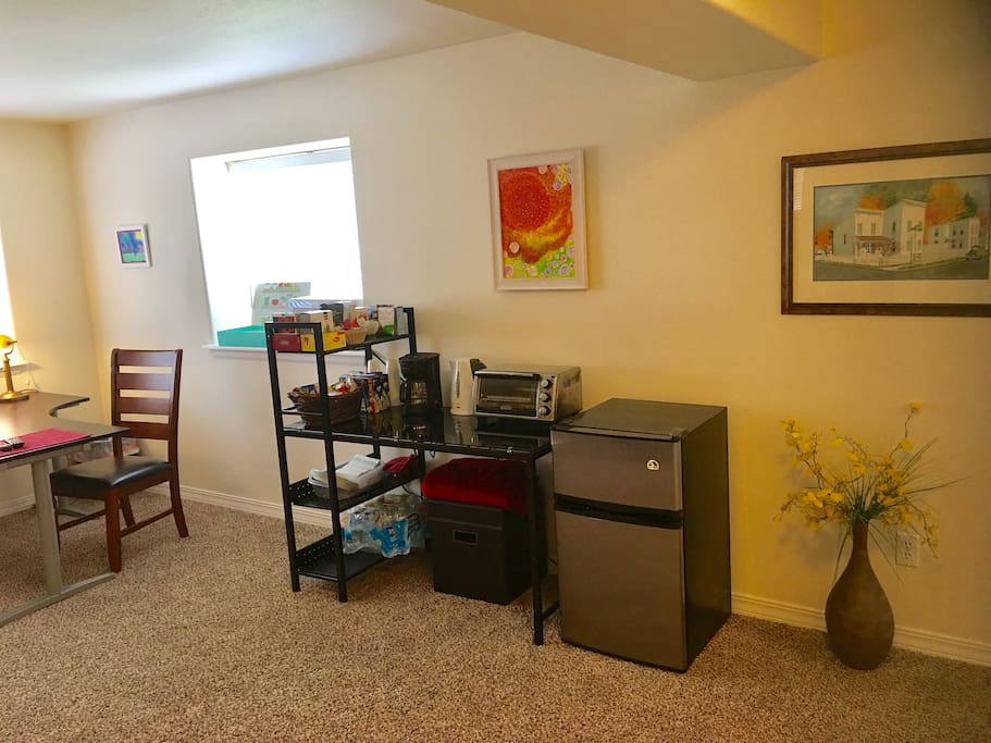 Breakfast nook with mini fridge, microwave, toaster oven, coffee maker and hot water heater