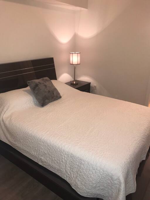 Second bedroom with queen bed and private bathroom.