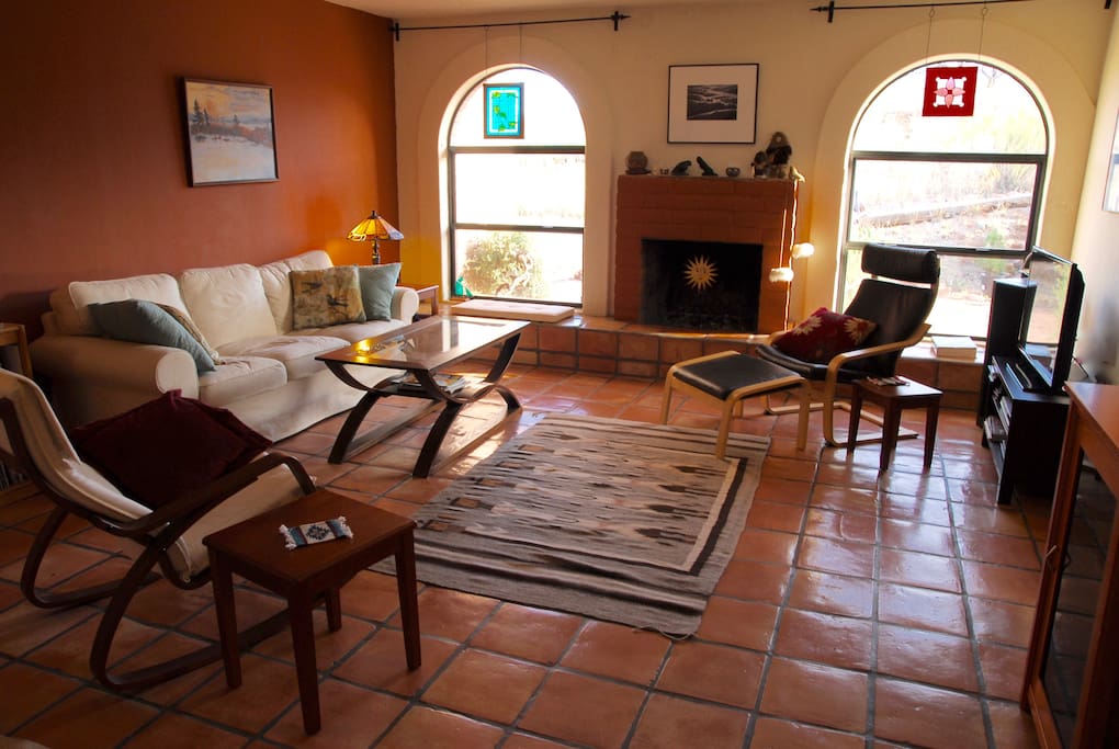Saltillo tiles and arched windows grace the sunken living room.