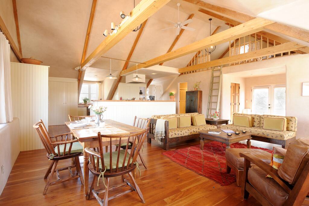 Open floor plan with dining area, living room, kitchen and sleeping loft