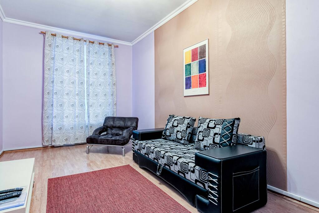 Couch and arm chair by the window which faces the courtyard