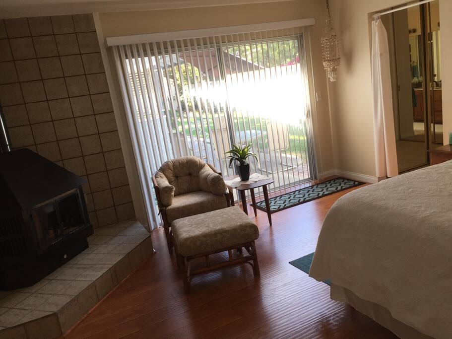 Sitting area in master bedroom; freestanding fireplace to left