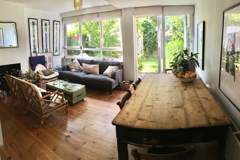 Our gorgeous outdoors-indoors dining/living room with large country farmhouse dining table and loads of comfy seating.