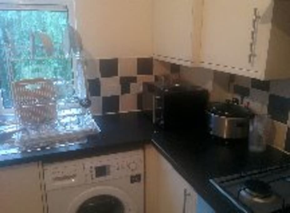 Kitchen with washing machine and cooker