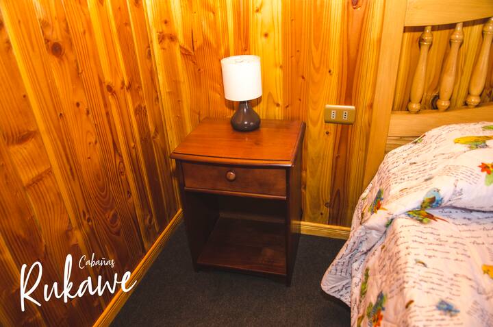 Room with queen bed, two candles and candle lamps 