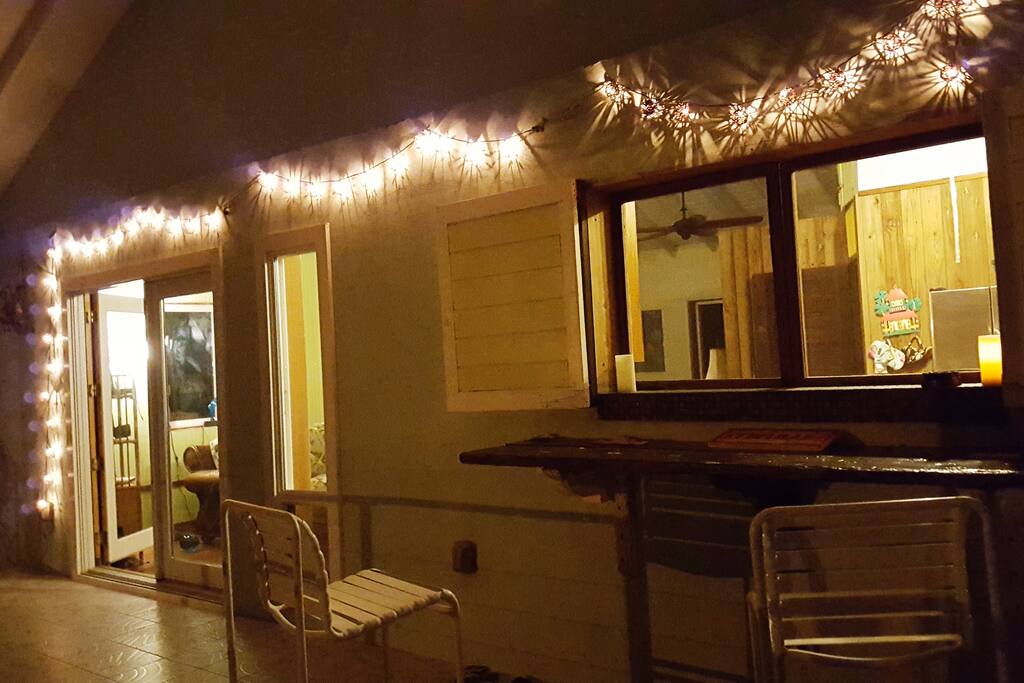 Night view of "Pass through" window of Tiki bar