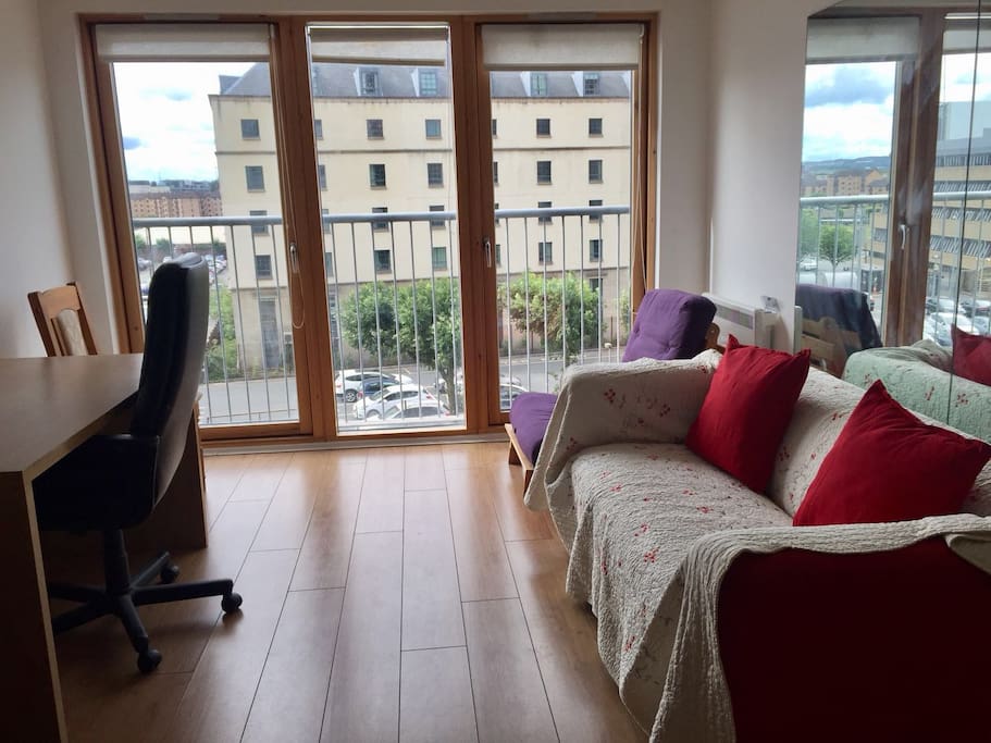 Living room with ceiling to floor glass door windows.