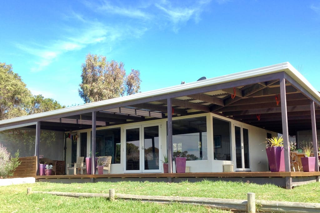 Large covered deck with seating, outdoor dining and BBQ area.