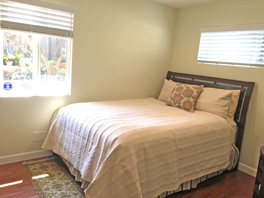 queen size bed in your bedroom with window looking out onto patio