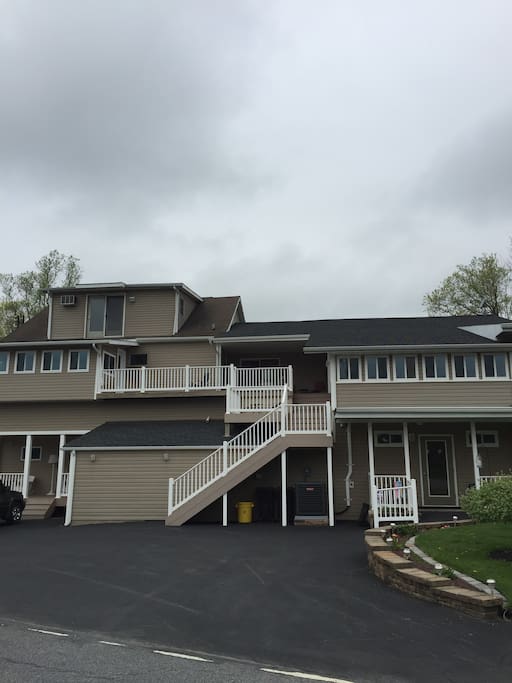 Outside of building, stairs to top of deck to enter apartment.