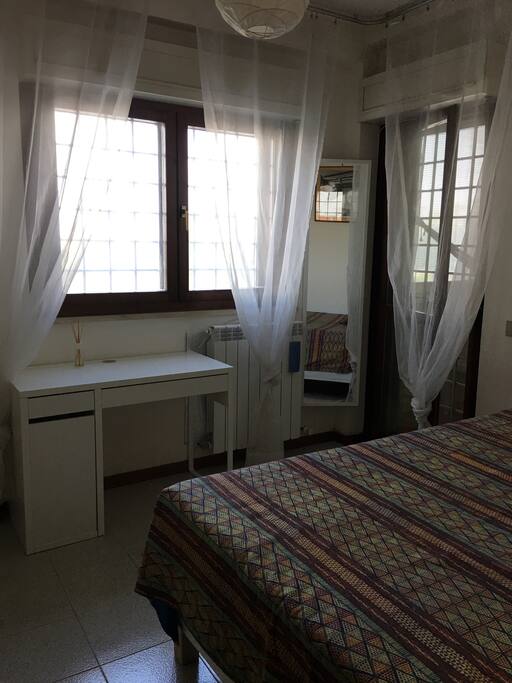 Bed, desk and windows