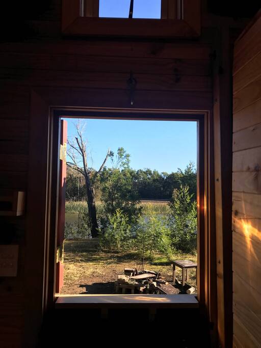 The view out the barn-style door is peaceful and relaxing