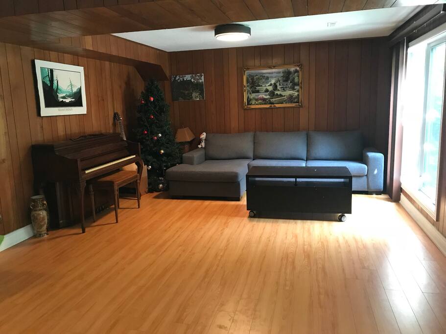 Living room with dinning table,piano,sofa set,mini bar,wood fire place in the walk-out bsmt
