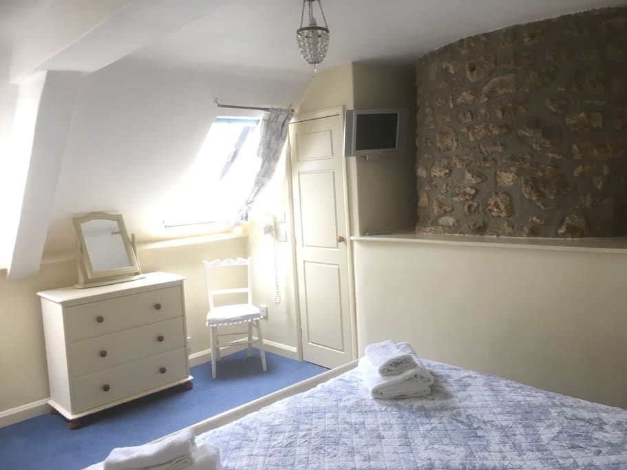 Double bedroom with the original stone chimney breast....
