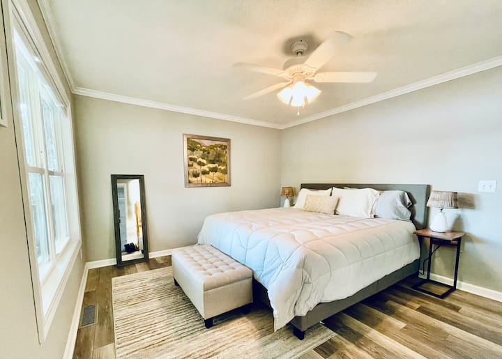Master bedroom with en-suite bathroom (large tiled shower), King platform bed with 12” memory foam mattress, two nightstands with USB and outlets in back, dresser, double closet, door to gated rear deck.  And of course, there is a lovely lake view.