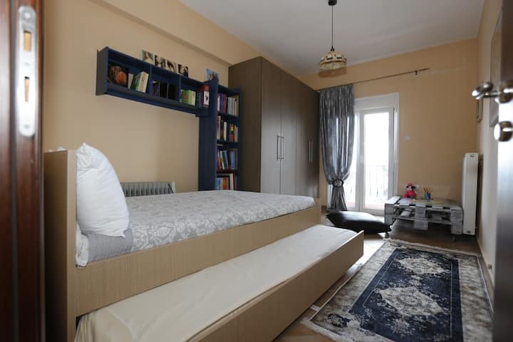 Semi-double bed with one more  single mattress underneath