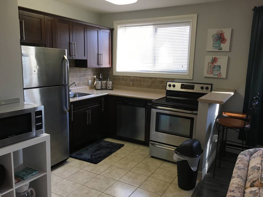 Fully equipped kitchen includes dishwasher, microwave, eating bar, dishes, pots and pans, etc.